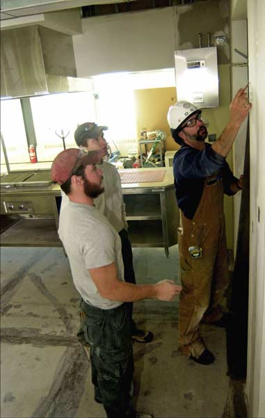 carpenters working in the kitchen area