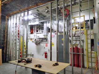 a new wall on the west side of the inflation room